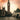 Big Ben and the Palace of Westminster with a bridge over the River Thames at sunset.