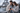 Couple looking at a smartphone with the Eiffel Tower in the background